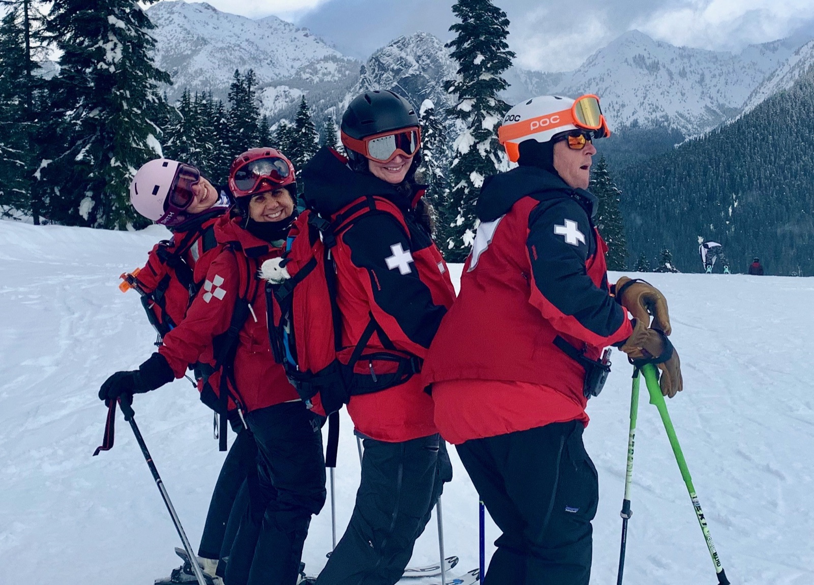 Four Summit Central patrollers laughing together on the slope